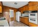 Traditional kitchen layout with classic wood cabinets and white appliances at 315 Burke Cir, Mcdonough, GA 30253