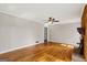 A spacious living room with gleaming hardwood floors and a ceiling fan for added comfort at 315 Burke Cir, Mcdonough, GA 30253