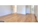 Spacious bedroom featuring light hardwood floors, white trim, and ensuite bathroom at 1947 Clark Dr, Tucker, GA 30084