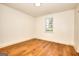 Bedroom featuring hardwood floors, a window for natural light, and white walls at 1947 Clark Dr, Tucker, GA 30084
