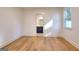 A bright bedroom features hardwood floors, white walls, and a bathroom doorway at 1947 Clark Dr, Tucker, GA 30084
