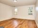 Bright bedroom with hardwood floors, two windows, and neutral color palette at 1947 Clark Dr, Tucker, GA 30084