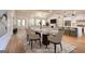 Spacious staged dining area open to the kitchen and living room with hardwood floors and modern lighting at 1947 Clark Dr, Tucker, GA 30084