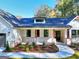 Beautiful front exterior with a walkway, manicured landscaping, and a covered porch with red accents and neutral brickwork at 1947 Clark Dr, Tucker, GA 30084