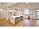 Modern kitchen featuring stainless appliances, island with quartz counters, hardwood floors, and recessed lighting at 1947 Clark Dr, Tucker, GA 30084