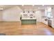 Open kitchen with a green island, stainless appliances, and white cabinetry at 1947 Clark Dr, Tucker, GA 30084
