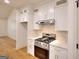 Well-lit kitchen area with stainless steel range, white cabinetry, and light countertops at 1947 Clark Dr, Tucker, GA 30084
