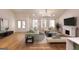 Virtually staged living room with neutral colors, fireplace, large windows, hardwood floors and plenty of natural light at 1947 Clark Dr, Tucker, GA 30084