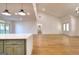 Open concept living room with hardwood floors, recessed lighting, and seamless flow to the kitchen at 1947 Clark Dr, Tucker, GA 30084