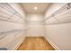 Spacious walk-in closet featuring custom shelving and hardwood floors at 1947 Clark Dr, Tucker, GA 30084