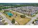 Aerial view of the neighborhood featuring a pond with fountain, gazebo, and community green space at 247 Widener Way, Peachtree City, GA 30269