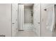 Clean bathroom featuring a tub/shower combo with tiled walls and a hanging towel at 247 Widener Way, Peachtree City, GA 30269