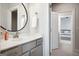 Bathroom featuring a round mirror, chrome faucet, and gray cabinets at 247 Widener Way, Peachtree City, GA 30269