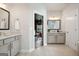 This bathroom has double sinks, and an open doorway to the primary bedroom at 247 Widener Way, Peachtree City, GA 30269