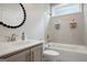 ' bathroom featuring a tub with tiled wall, showerhead, storage, and sink at 247 Widener Way, Peachtree City, GA 30269