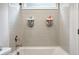 Tub with tiled wall and showerhead in a bright ' bathroom at 247 Widener Way, Peachtree City, GA 30269