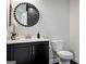 Stylish powder room features a modern vanity, round mirror, and elegant fixtures at 247 Widener Way, Peachtree City, GA 30269
