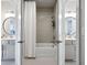 Bright bathroom featuring dual sinks, tub and shower combo with a white shower curtain at 247 Widener Way, Peachtree City, GA 30269