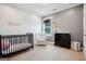Cozy Bedroom with crib, chair, changing table, and natural light from the window at 247 Widener Way, Peachtree City, GA 30269
