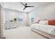Bright bedroom featuring a daybed, white dresser, and a modern ceiling fan at 247 Widener Way, Peachtree City, GA 30269