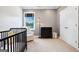 Bright Bedroom featuring a crib, chair, changing table, and window with view to the outside at 247 Widener Way, Peachtree City, GA 30269