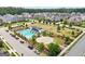 Aerial view of a community pool with lounge chairs and umbrellas surrounded by lush landscaping at 247 Widener Way, Peachtree City, GA 30269