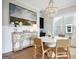Well-lit dining room with white paneled walls, a modern chandelier, and a decorative antique console table at 247 Widener Way, Peachtree City, GA 30269