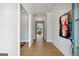 Bright entryway with hardwood floors, white trim, and an abstract painting on the wall at 247 Widener Way, Peachtree City, GA 30269