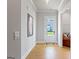 Hallway featuring hardwood floors, white trim, leading to an entry door and living area at 247 Widener Way, Peachtree City, GA 30269
