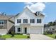Stunning two-story home featuring a bright white facade, dark shutters, and a well-manicured front yard at 247 Widener Way, Peachtree City, GA 30269