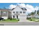 Elegant two-story home showcasing a white exterior, dark shutters, and a neatly maintained front lawn with landscaping at 247 Widener Way, Peachtree City, GA 30269