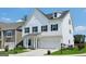 Charming two-story home with a clean white exterior, black shutters, and a neatly landscaped front lawn at 247 Widener Way, Peachtree City, GA 30269