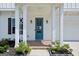 Inviting front entrance with a blue door, brick walkway and pillars providing curb appeal at 247 Widener Way, Peachtree City, GA 30269