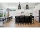 Spacious modern kitchen with a black island, white cabinets, pendant lights, and an adjacent dining area at 247 Widener Way, Peachtree City, GA 30269