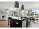 Open concept kitchen with large island, modern lighting, stainless steel appliances, and large windows at 247 Widener Way, Peachtree City, GA 30269