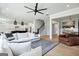 Spacious living room with fireplace, stairs, modern decor, and an open floor plan at 247 Widener Way, Peachtree City, GA 30269