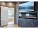 The primary bedroom includes a modern fireplace, a tv, and an open doorway into the ensuite bathroom at 247 Widener Way, Peachtree City, GA 30269