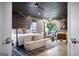 Comfortable main bedroom features a four-poster bed, accent lighting, and ample natural light at 247 Widener Way, Peachtree City, GA 30269
