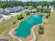 Aerial view of the community pond with fountain and landscaped surroundings near neighborhood homes at 247 Widener Way, Peachtree City, GA 30269