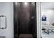 Contemporary shower with dark tile and sleek fixtures, offering a spa-like experience at 247 Widener Way, Peachtree City, GA 30269