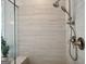 This walk-in shower features light colored tile, a rainfall shower head, and a small seating bench at 247 Widener Way, Peachtree City, GA 30269