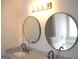 Bathroom showcasing double sinks, granite countertop and modern fixtures with a view into the bath and shower at 4383 Chestnut Lake Ave, Lithonia, GA 30038