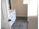 Bathroom vanity with granite countertops and dark tile flooring at 4383 Chestnut Lake Ave, Lithonia, GA 30038
