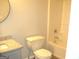 Well-lit bathroom featuring a combined shower and tub unit, toilet and granite vanity at 4383 Chestnut Lake Ave, Lithonia, GA 30038