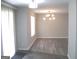 Sunlit dining room with gray floors, modern lighting, and sliding door access at 4383 Chestnut Lake Ave, Lithonia, GA 30038