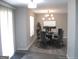 Dining room features seating for six and a modern chandelier at 4383 Chestnut Lake Ave, Lithonia, GA 30038