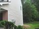 Side view of the house showing the siding, landscaping, and a utility meter at 4383 Chestnut Lake Ave, Lithonia, GA 30038