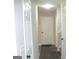 Hallway featuring tile floors, neutral walls, and multiple doors at 4383 Chestnut Lake Ave, Lithonia, GA 30038