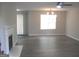 Inviting living room with new flooring, a cozy fireplace, and large window at 4383 Chestnut Lake Ave, Lithonia, GA 30038