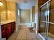 Bathroom featuring tile flooring, shower stall with glass doors, and large vanity with storage at 180 Oakland Hills Way, Lawrenceville, GA 30044